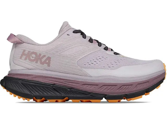 Lateral view of the Women's Stinson 6 trail shoe by HOKA in the color Lilac Marble / Blue Graphite