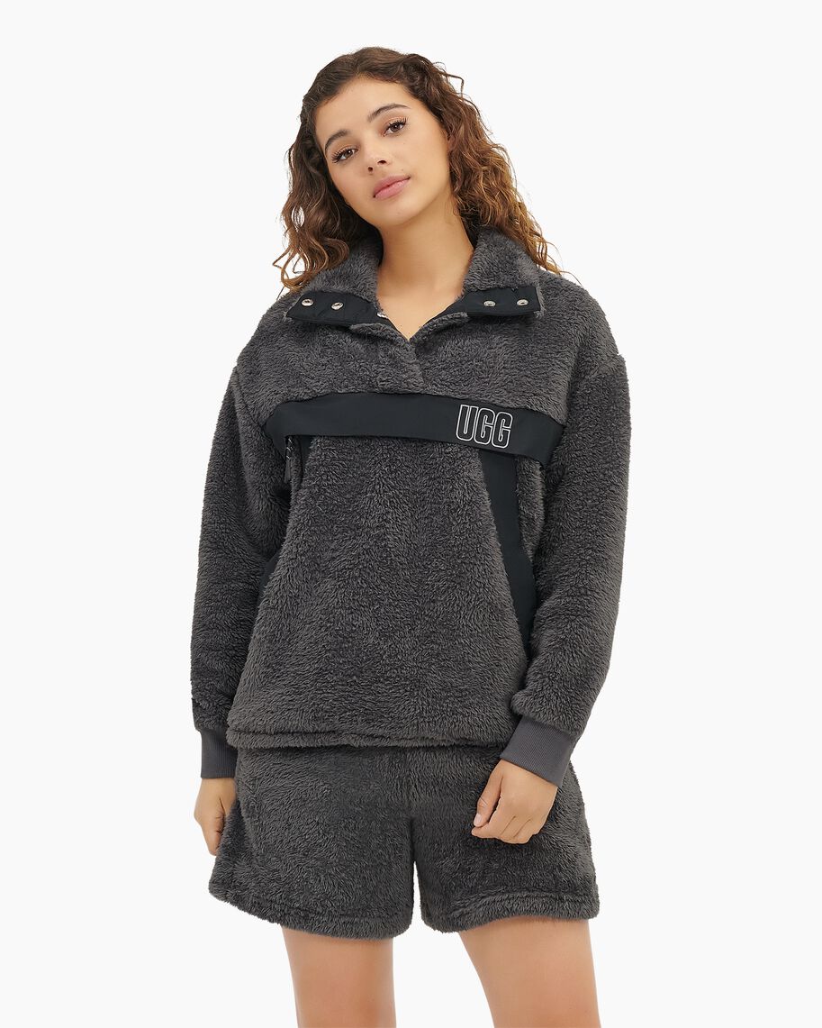 Take your outfit to the next level with this half-snap sherpa pullover featuring sporty nylon trim for bold contrast. Incredibly cozy, it's the perfect item to live in when it is cold outside.