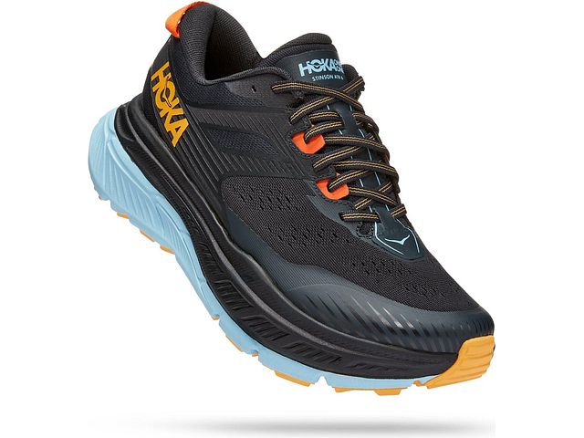 Lateral angled view of the Men's Stinson (All Terrain) shoe by HOKA in the color Blue Graphite / Summer Song