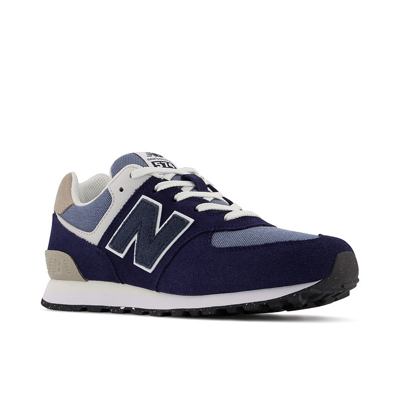The unassuming, unpretentious versatility is exactly what launched the New Balance 574 into the ranks of all-time great Lifestyle Shoes.  This Kid's version is a takedown from that classic style.    As hybrid road/trail design built on a wider last than the previous generation’s narrow racing silhouettes, the 574 offered a uniquely versatile mix of new, different, uncomplicated, rugged, durable, and comfortable that was adopted as a closet staple across the globe.