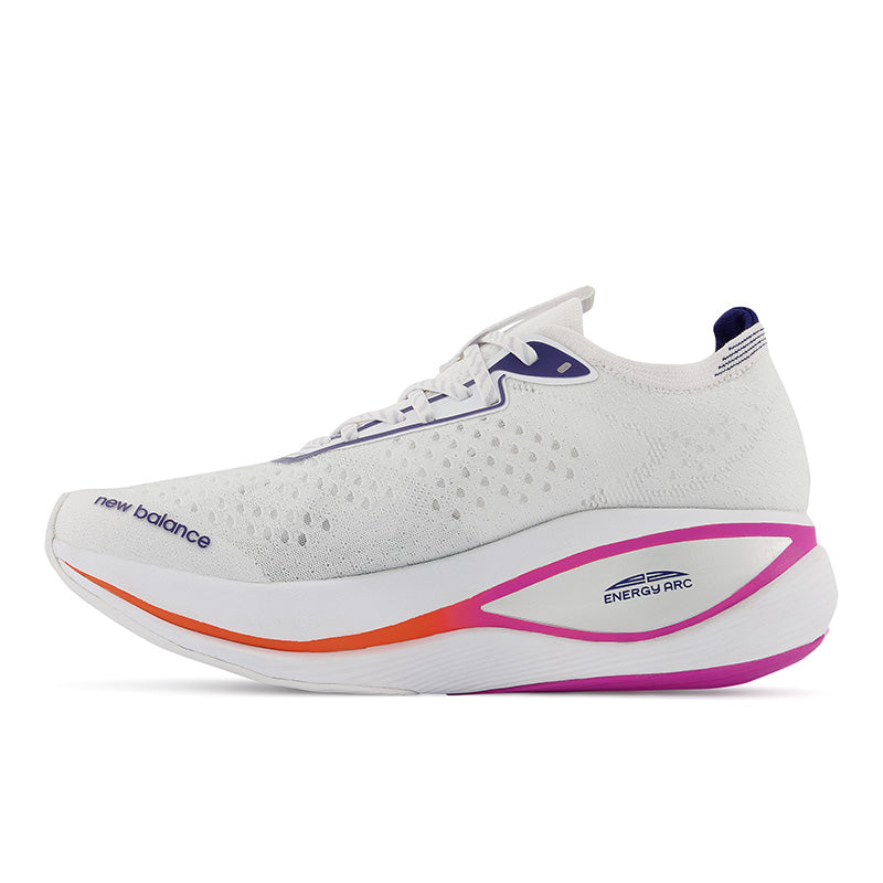 Medial view of the Men's Fuel Cell SuperComp Trainer by New Balance in the color White/Victory Blue/Magenta Pop