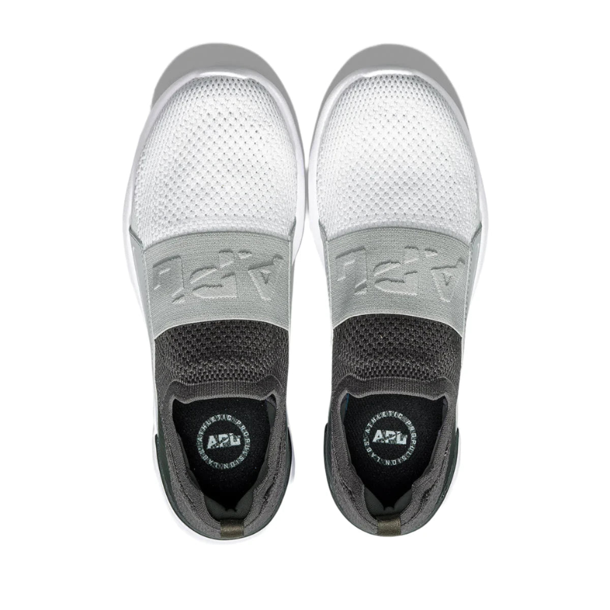 The topdown view of this colors way of the APL Bliss details a white knitted material over the forefoot, along with a branded APL elastic piece over the instep as well as an anthracite color around the heel and top of the shoe