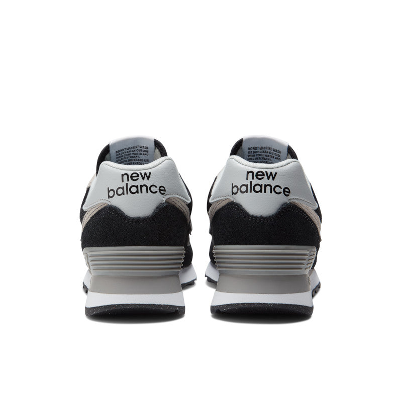 Back view of the Women's New Balance 574 lifestyle shoe in Black/White
